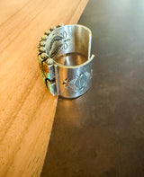 Navajo Silver cuff with engraved designs on a wooden surface